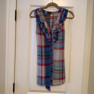 Tunic length sleeveless blouse. Ties in back.